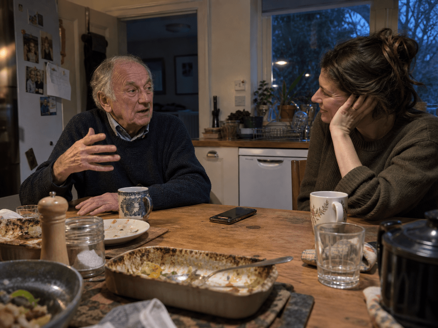 A daughter listening while her father tells a story at the kitchen table
